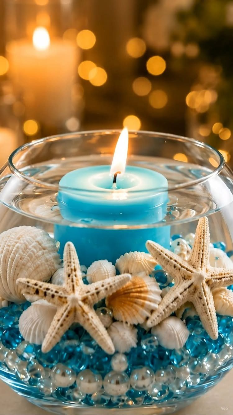 Blue floating candle in a glass bowl with starfish and seashells