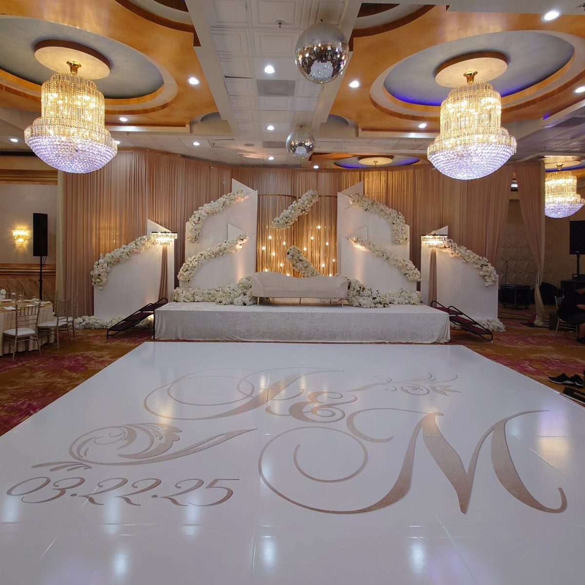 White glossy wedding dance floor with gold monogram initials and a date.