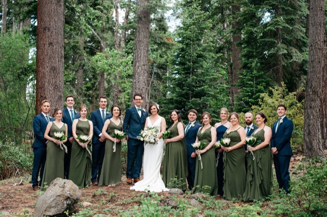 Wedding party in a forest with bridesmaids wearing olive green gowns.