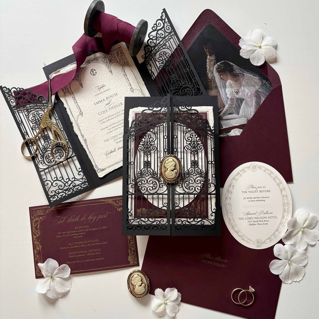 Gothic wedding invitations with burgundy envelopes, black laser-cut details, and gold wax seals.