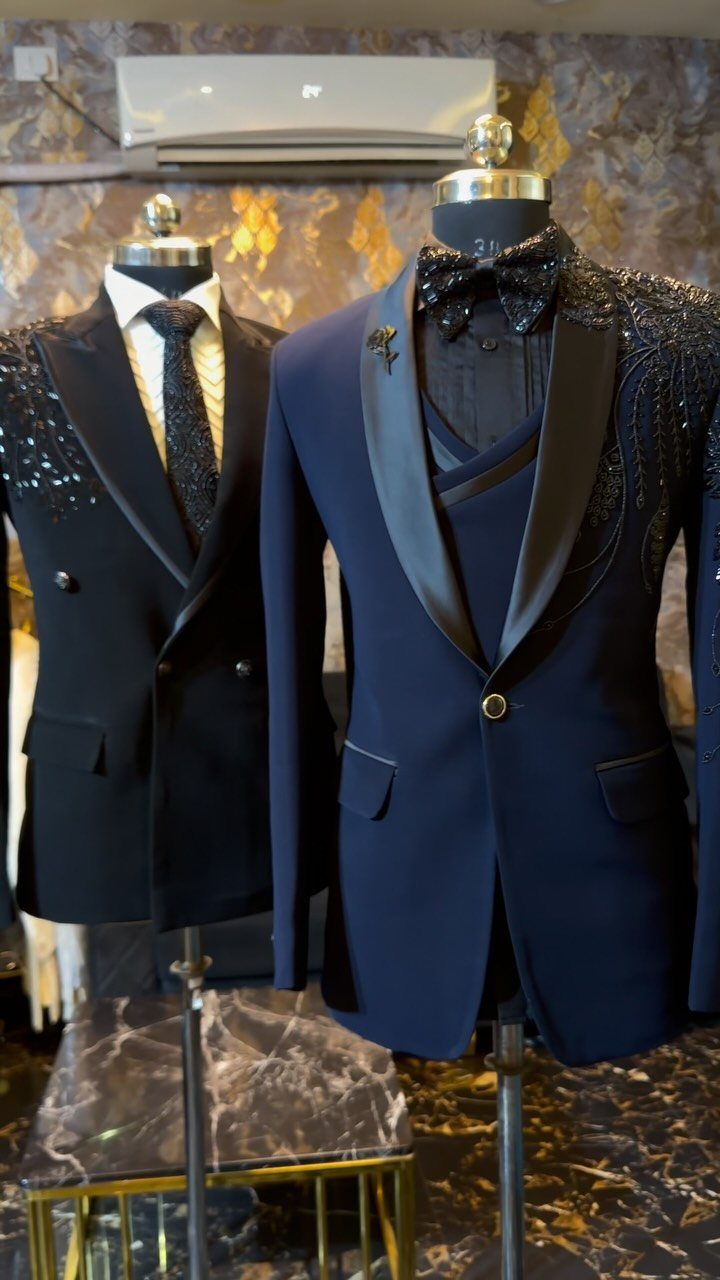 Navy blue formal suit with satin lapels and bow tie on a mannequin.