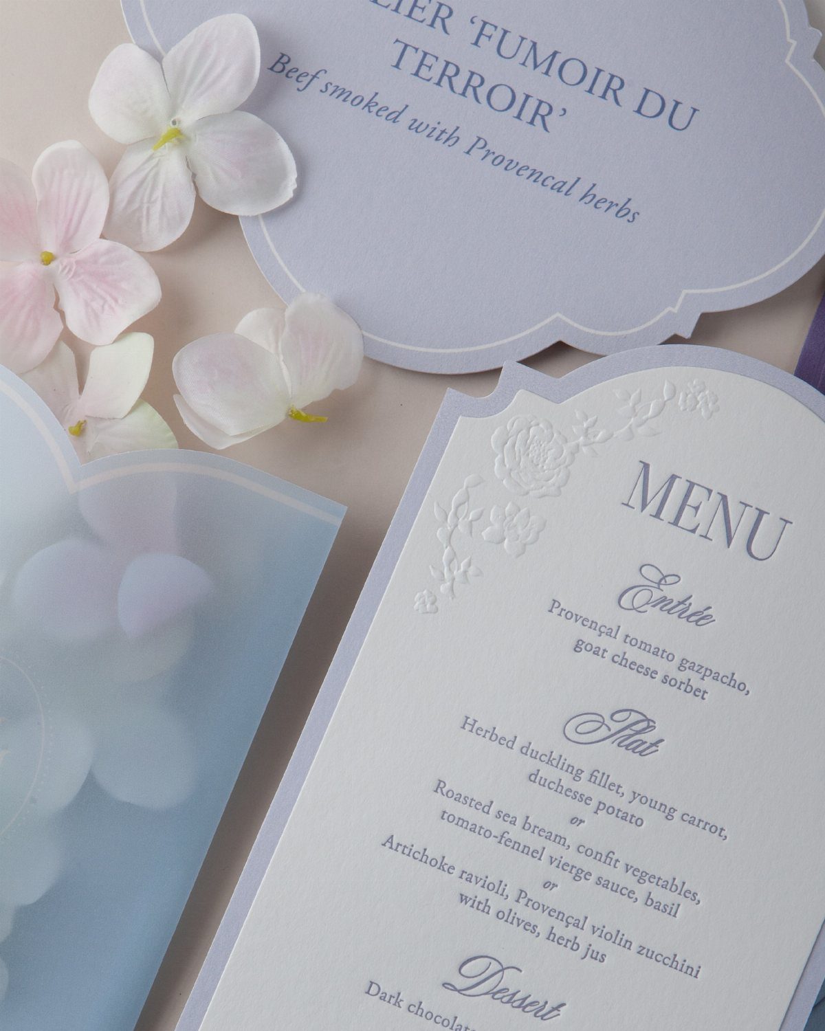 Wedding menu card with purple accents and pale purple hydrangea petals.