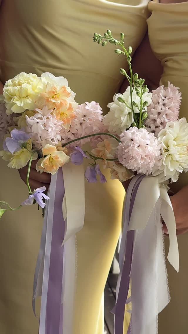 Butter yellow dress and bouquets with pale lilac and yellow flowers and ribbons.
