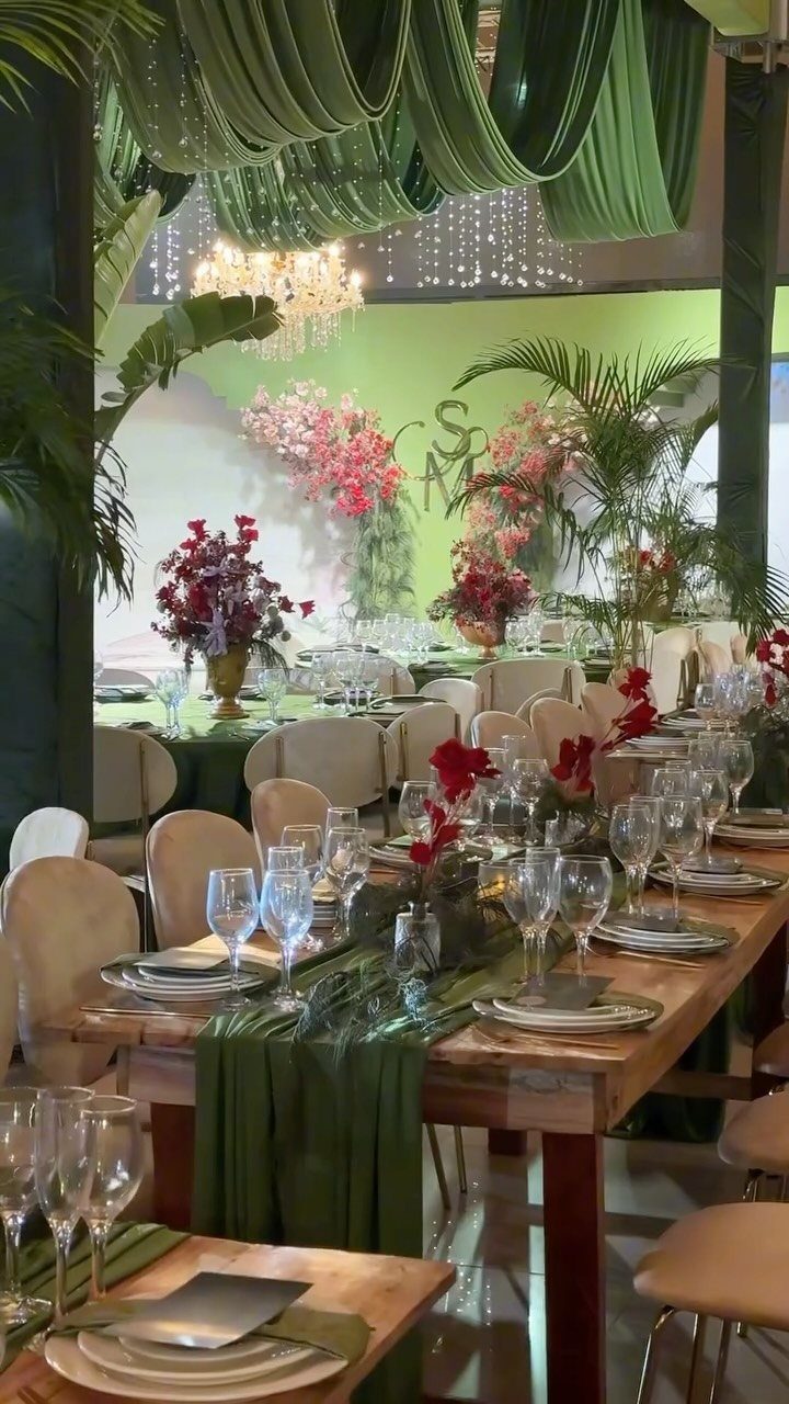 Wooden wedding table with forest green runners and matching draped ceiling fabric.