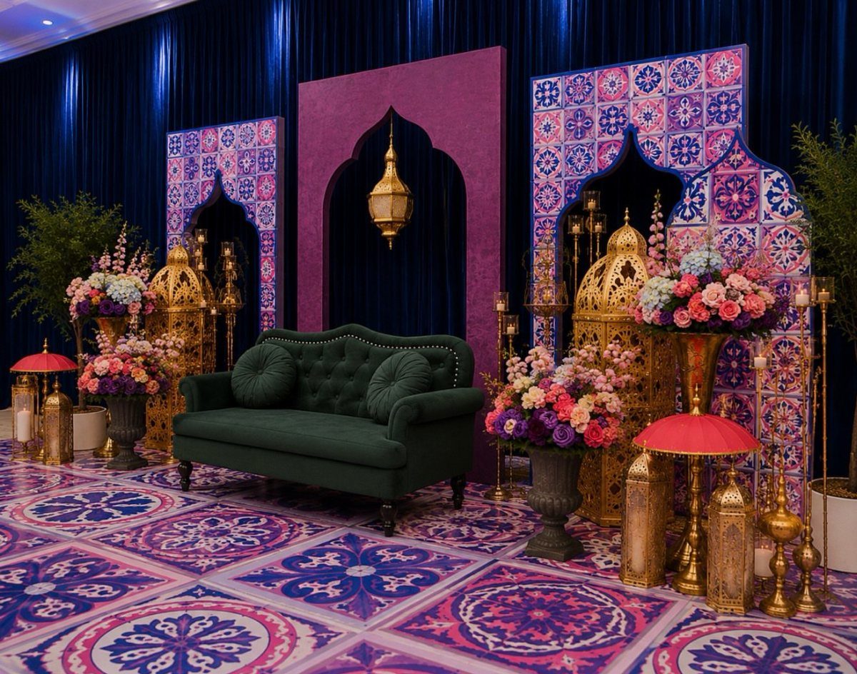 Gold Moroccan lanterns and a green velvet sofa in a colorful ornate setting