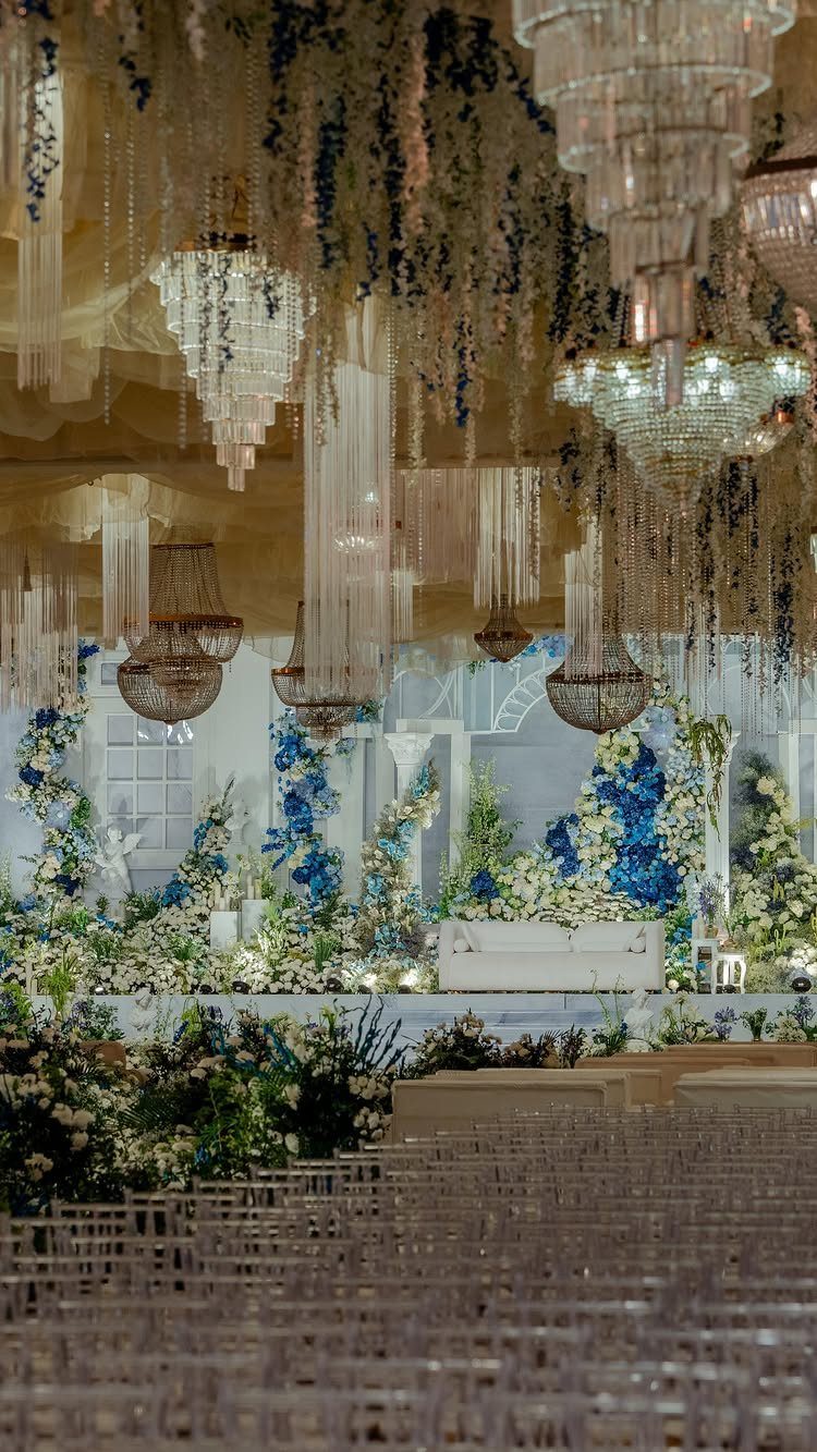 Blue and white floral walls and arrangements in a luxury wedding hall.