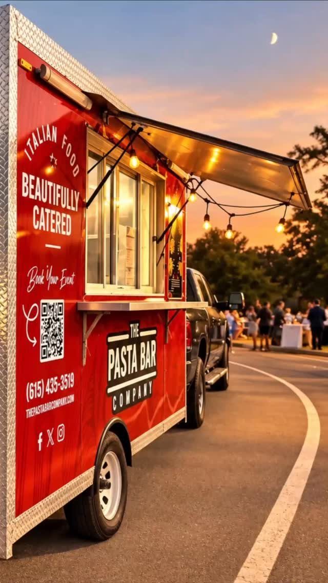 Red pasta bar food trailer with open serving window and string lights at dusk