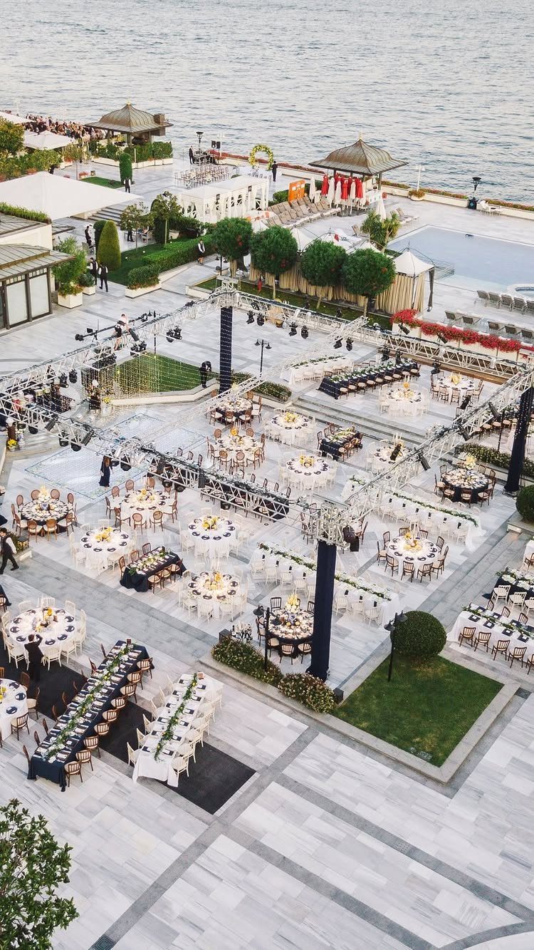 Outdoor wedding reception with a mix of round and long rectangular dining tables.