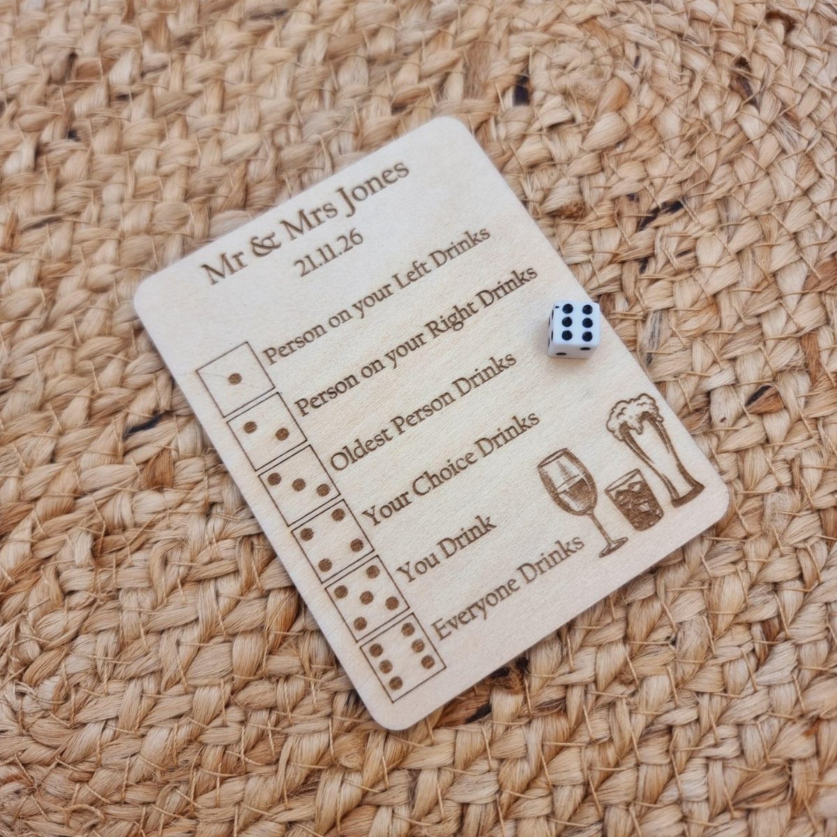 Wooden wedding drinking game board with a die on a woven straw mat