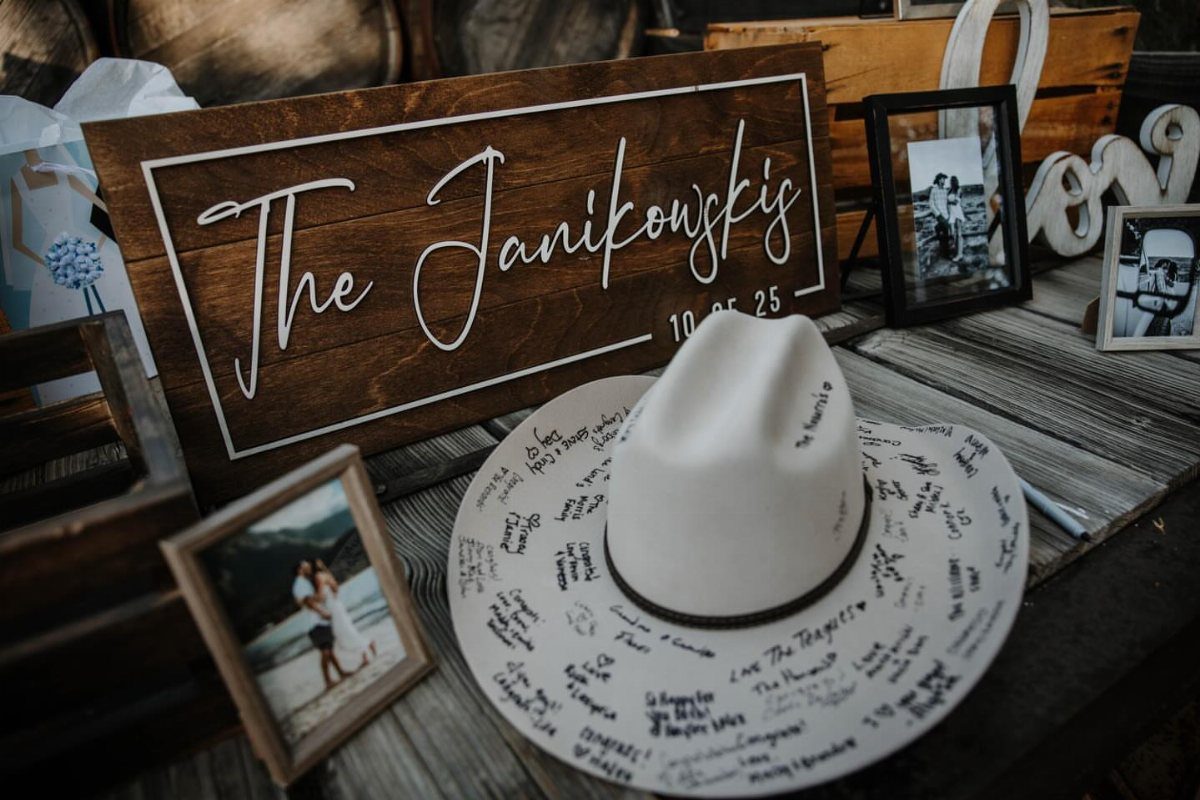 White cowboy hat used as a guest book with handwritten messages on a table