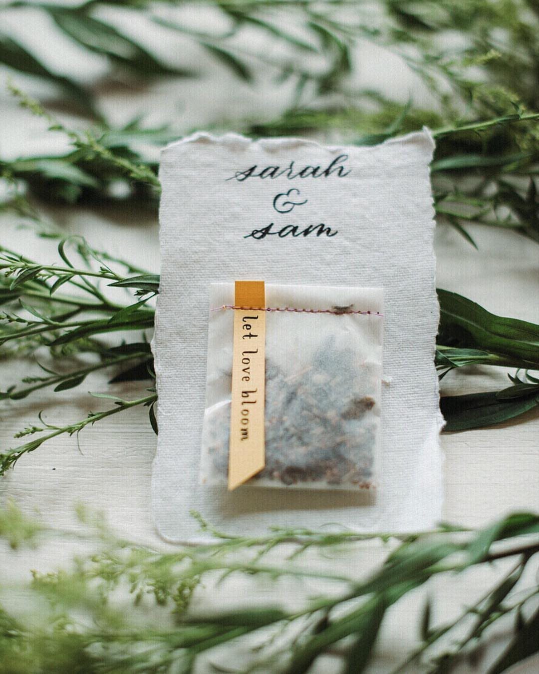 Seed packet wedding favor with a yellow tag on a personalized card.